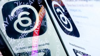 This photo illustration created in Washington, DC, on July 6, 2023, shows the logo for Threads, an Instagram app, reflected in its opening page.