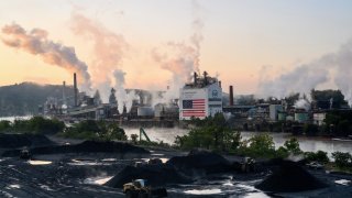 A tugboat pushes a barge near the U.S. Steel Corp. Clairton Coke Works facility in Clairton, Pennsylvania, on Sept. 9, 2024.
