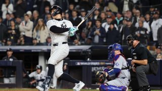 Aaron Judge #99 of the New York Yankees hits a single against the Los Angeles Dodgers in the sixth inning during Game Three of the 2024 World Series at Yankee Stadium on October 28, 2024 in the Bronx borough of New York City.