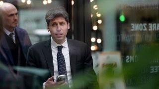 Sam Altman, CEO of OpenAI, is seen through glass, during an event on the sidelines of the Artificial Intelligence Action Summit in Paris, France, on Feb. 11, 2025.