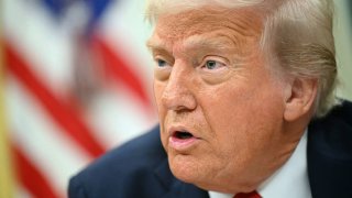 US President Donald Trump signs an executive order targeting ticket scalping in the Oval Office of the White House in Washington, DC, on March 31, 2025.