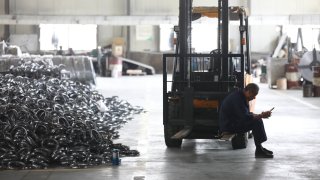 A worker rests in a factory making steel bike rims for export to the U.S. in Hangzhou in east China’s Zhejiang province Friday, April 11, 2025.
