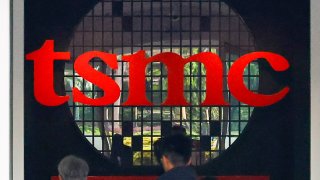 A motorcycle is seen near a building of the Taiwan Semiconductor Manufacturing Company (TSMC), which is a Taiwanese multinational semiconductor contract manufacturing and design company, in Hsinchu, Taiwan, on April 16, 2025.