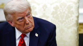 President Donald Trump listens to reporters’ questions as he meets with Italian Prime Minister Giorgia Meloni in the Oval Office at the White House on April 17, 2025 in Washington, DC.