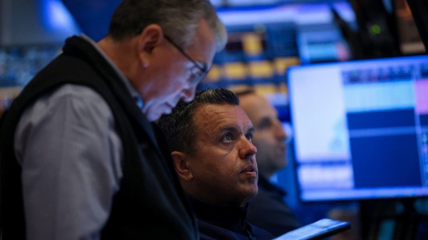 Traders work on the floor at the New York Stock Exchange in New York City, U.S., April 21, 2025.
