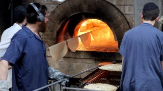 Orthodox Jewish men bake Matzot (unleavened bread) at a bakery in Kfar Habad in central Israel