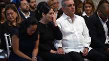 Dominican Republic's President Luis Abinader (R) and his wife Raquel Arbaje (C) attend the wake of famed merengue singer Rubby Perez, who died after the roof of the Jet Set nightclub where he was performing collapsed, at the National Theatre in Santo Domingo on April 10, 2025. The death toll in the collapse has reached 218, security forces reported, as they concentrate on finding the last bodies in the area of the tragedy. More than 500 people were injured in the April 8 incident. (Photo by Martin BERNETTI / AFP) (Photo by MARTIN BERNETTI/AFP via Getty Images)