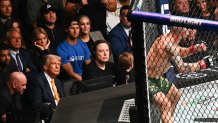 US actress Cheryl Hines plugs her ears as she sits with her husband US Secretary of Health and Human Services Robert F. Kennedy Jr., US President Donald Trump with Elon Musk and his son X Æ A-12 watching the featherweight fight between Australian fighter Alexander Volkanovski and Brazilian fighter Diego Lopes (off frame) during UFC 314 at the Kaseya Center in Miami, Florida, in the early hours of April 13, 2025. (Photo by Mandel NGAN / AFP) (Photo by MANDEL NGAN/AFP via Getty Images)