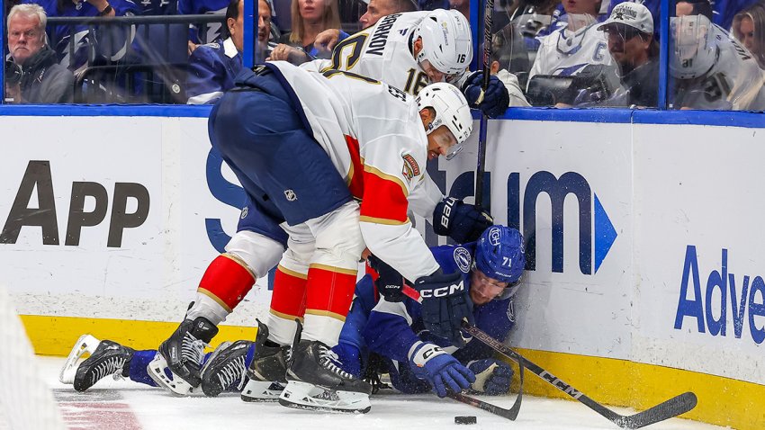 TAMPA, FL – APRIL 24: Anthony Cirelli #71 of the Tampa Bay Lightning reaches for a puck after being hit by Aleksander Barkov #16 and Seth Jones #3 of the Florida Panthers in the second period of Game Two of the First Round of the 2025 Stanley Cup Playoffs at the Amalie Arena on April 24, 2025 in Tampa, Florida. (Photo by Mike Carlson/Getty Images)