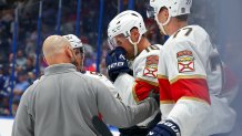 TAMPA, FL - APRIL 24: Aleksander Barkov #16 of the Florida Panthers is attended to by a trainer after being injured on a check by Brandon Hagel #38 of the Tampa Bay Lightning in the third period of Game Two of the First Round of the 2025 Stanley Cup Playoffs at the Amalie Arena on April 24, 2025 in Tampa, Florida. Hagel was given a five-minute penalty for interference on the play. (Photo by Mike Carlson/Getty Images)