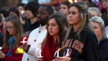 TALLAHASSEE, FL- NOVEMBER 20: Florida State University student Colleen Rick (R) joins fellow students during the Gathering of Unity candlelight vigil on campus after the shooting of three FSU students earlier in the day on November 20, 2014 in Tallahassee, Florida. About 3,000 students attended the vigil according to FSU Police Chief David Perry. (Photo by Mark Wallheiser/Getty Images)