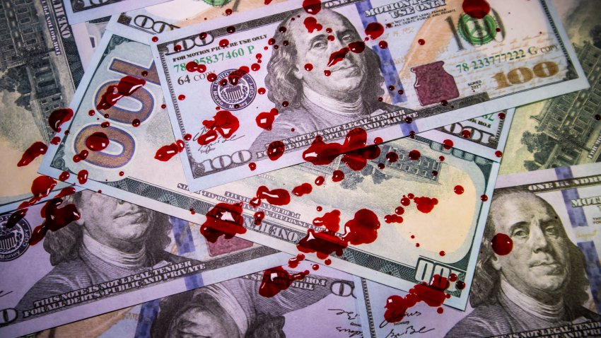 Money covered in blood droplets