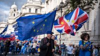 Protestors march with large flags during The National Rejoin March. Pro-EU groups demonstrated in central London, UK.
