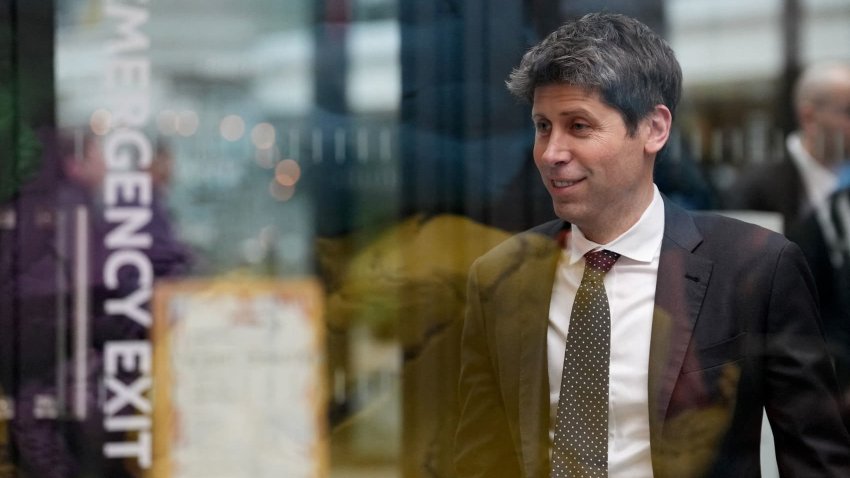 Sam Altman, CEO of OpenAI, is seen through glass during an event on the sidelines of the Artificial Intelligence Action Summit in Paris, Feb. 11, 2025.