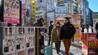 TOPSHOT – Customers enter an electronics shop in the Akihabara district of Tokyo on January 12, 2024. 