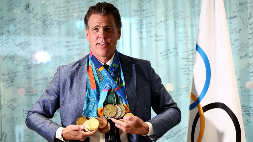 Gary Hall Jr. (L) poses wearing the replica Olympic medals