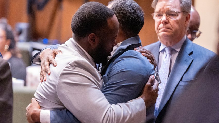Former police officers hug