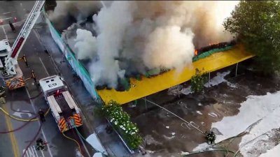 Firefighter hurt as crews battle massive blaze at vacant lumber warehouse in Miami