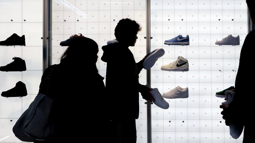 FILE – People shop for shoes in a Nike store on Nov. 25, 2022, in New York.