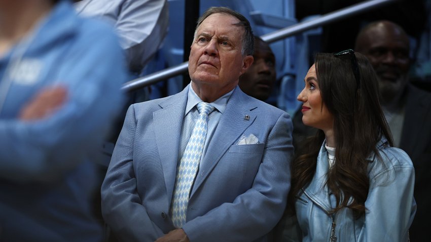 FILE - North Carolina football head coach Bill Belichick and girlfriend Jordon Hudson look on during the first half of the game between the North Carolina Tar Heels and the Duke Blue Devils at Dean E. Smith Center on March 8, 2025, in Chapel Hill, North Carolina.