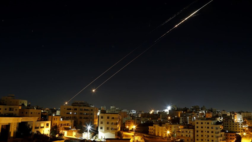 Missiles fired from Iran in retaliation for Israeli attacks are seen in the sky over the Hebron, West Bank on June 21, 2025.