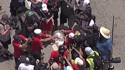 Florida Panthers players drinking out of Stanley Cup during parade