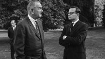 FILE - President Lyndon B. Johnson, right, talks with press secretary Bill Moyers on the South Lawn of the White House in Washington on Aug. 30, 1965. (AP Photo/William J. Smith, File)