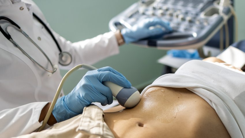 Doctor examines woman with ultrasound