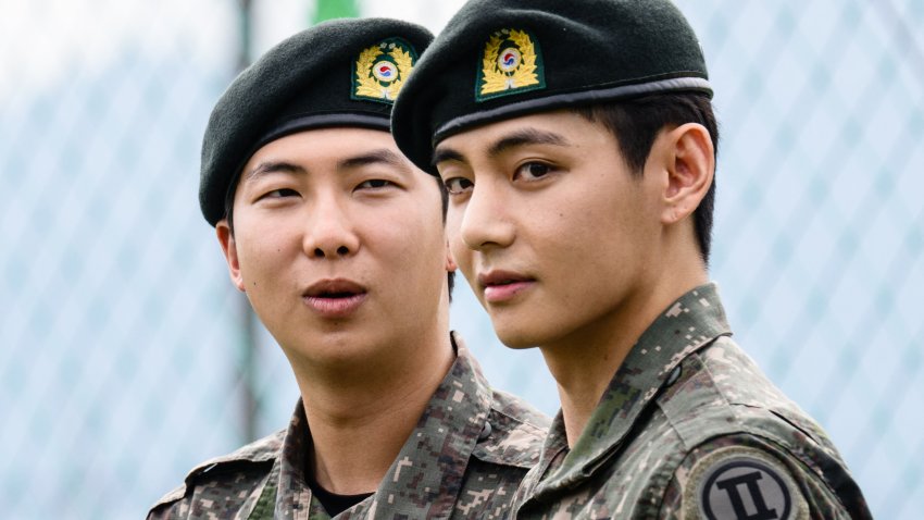 K-pop boy band BTS member V looks on as RM reacts at an outdoor sporting facility in Chuncheon on June 10, 2025, after their release from 18 months of South Korean military service. Hundreds of fans gathered near two army bases just outside of the capital Seoul where band leader RM — recently named “Favorite K-pop Artist” at the American Music Awards — and singer V were discharged.