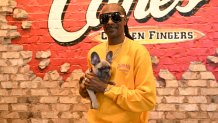 LAS VEGAS, NEVADA - JULY 23: Snoop Dogg works a surprise "shift" at Raising Cane's in Vegas ahead of National Chicken Finger Day on July 27 at Raising Cane's on July 23, 2025 in Las Vegas, Nevada. (Photo by Denise Truscello/Getty Images for Raising Cane's)