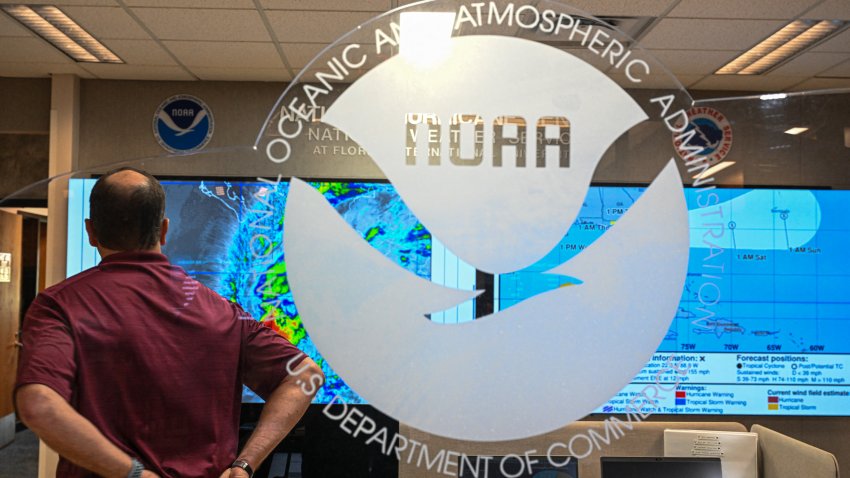 An employee of National Hurricane Center looks at the multiple hurricane models displayed on the monitors at the National Oceanic and Atmospheric Administration’s (NOAA) National Hurricane Center in Miami, Florida, on May 30, 2025. The administration of US President Donald Trump has fired hundreds of staff at the National Oceanic and Atmospheric Administration (NOAA) and deleted government websites with data on the weather and climate. (Photo by CHANDAN KHANNA / AFP) (Photo by CHANDAN KHANNA/AFP via Getty Images)