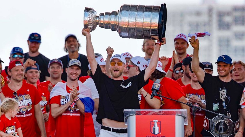 Florida Panthers center Sam Bennett (9) hoists the Stanley Cup as teammates celebrate on stage during the team’s victory parade and rally along A1A on Sunday, June 22, 2025, in Fort Lauderdale, Florida. (Al Diaz/Miami Herald/Tribune News Service via Getty Images)
