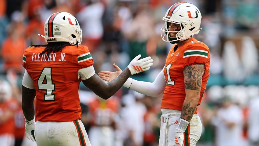 MIAMI GARDENS, FLORIDA – SEPTEMBER 13: Carson Beck #11 of the Miami Hurricanes  and Mark Fletcher Jr. #4 of the Miami Hurricanes celebrate Beck’s pass for a touchdown against the South Florida Bulls during the first half at Hard Rock Stadium on September 13, 2025 in Miami Gardens, Florida. (Photo by Carmen Mandato/Getty Images)