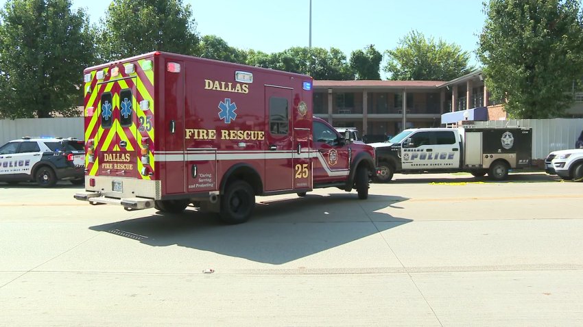 Image of Dallas police and an ambulance at a motel where a man was stabbed then beheaded.