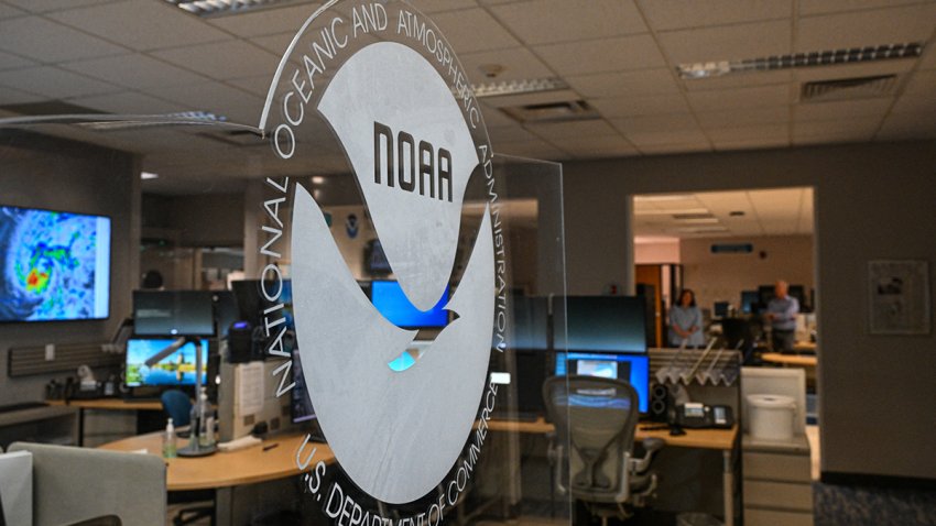 The logo of the National Oceanic and Atmospheric Administration’s (NOAA) is seen during a news conference at the National Hurricane Center in Miami, Florida, on May 30, 2025. The administration of US President Donald Trump has fired hundreds of staff at the National Oceanic and Atmospheric Administration (NOAA) and deleted government websites with data on the weather and climate. (Photo by CHANDAN KHANNA / AFP) (Photo by CHANDAN KHANNA/AFP via Getty Images)