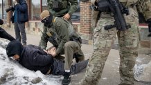MINNEAPOLIS, MINNESOTA - JANUARY 11: Border Patrol agents take a man into custody on January 11, 2026 in Minneapolis, Minnesota. The Trump administration has sent an estimated 2,000 federal immigration agents into the area in a push to arrest undocumented immigrants. (Photo by Scott Olson/Getty Images)