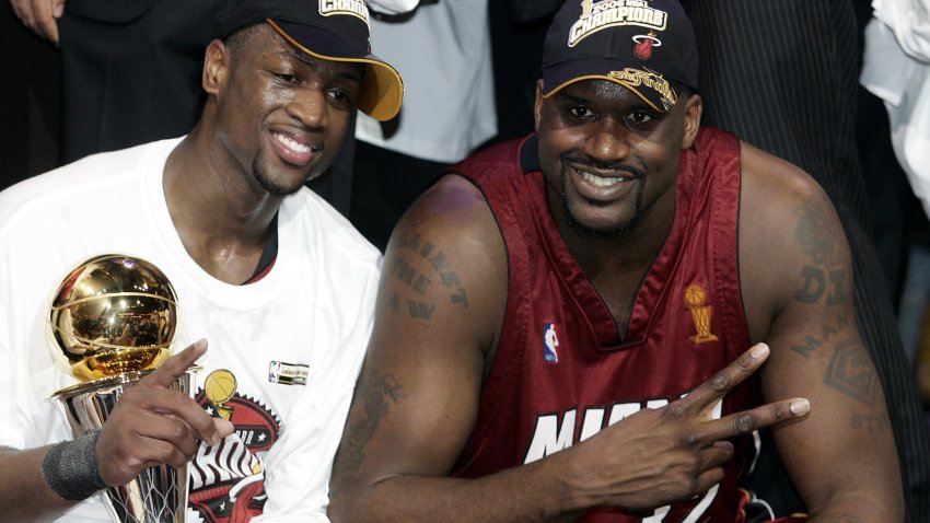 Dwyane Wade (L) and Shaquille O’Neal (R) of the Miami Heat celebrate after winning the NBA Finals 95-92 in Game Six against the Dallas Mavericks 20 June 2006 at the American Airlines Center in Dallas Texas.  Dwyane Wade was named MVP leading the Heat to 4-2 best-of-seven series victory.      AFP PHOTO/Jeff HAYNES (Photo credit should read JEFF HAYNES/AFP via Getty Images)