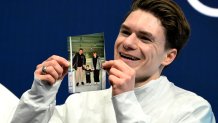 Maxim Naumov holds a picture of his parents