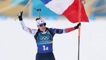 Julia Simon of Team France holding French flag