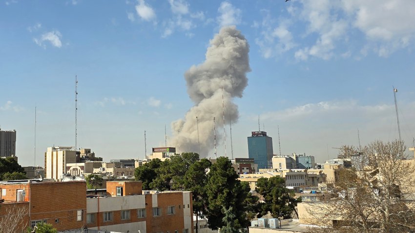 A plume of smoke rises after an explosion on February 28, 2026, in Tehran, Iran.