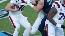 New England Patriots quarterback Drake Maye is sacked