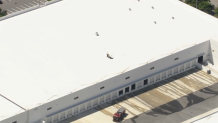 Crews respond after a helicopter crashed into a warehouse in Boynton Beach on March 23, 2026.