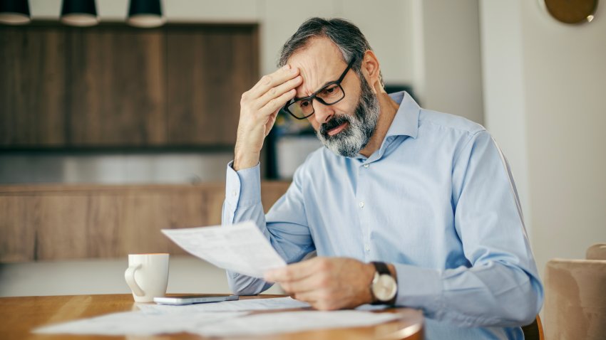Worried man calculating bills