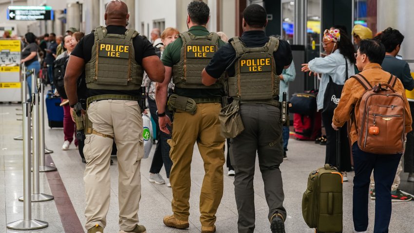 Immigration and Customs Enforcement (ICE) agents as travelers wait in line to be screened at a Transportation Security Administration (TSA) checkpoint at Hartsfield-Jackson Atlanta International Airport (ATL) in Atlanta, Georgia, US, on Monday, March 23, 2026. President Donald Trump said he’s ready to deploy Immigration and Customs Enforcement agents to US airports as soon as Monday if congressional Democrats dont agree to a plan for funding parts of the Department of Homeland Security. Photographer: Elijah Nouvelage/Bloomberg via Getty Images