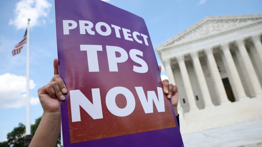 WASHINGTON, DC – JUNE 25: An immigration activist holds a sign during a rally against the U.S. Supreme Court’s ruling on temporary protective status outside of the Supreme Court on June 25, 2026 in Washington, DC. The Supreme Court ruled 6-3 in Mullin v. Doe, clearing the way for the Trump administration to end removal protections for Syrian and Haitian nationals. (Photo by Kevin Dietsch/Getty Images)