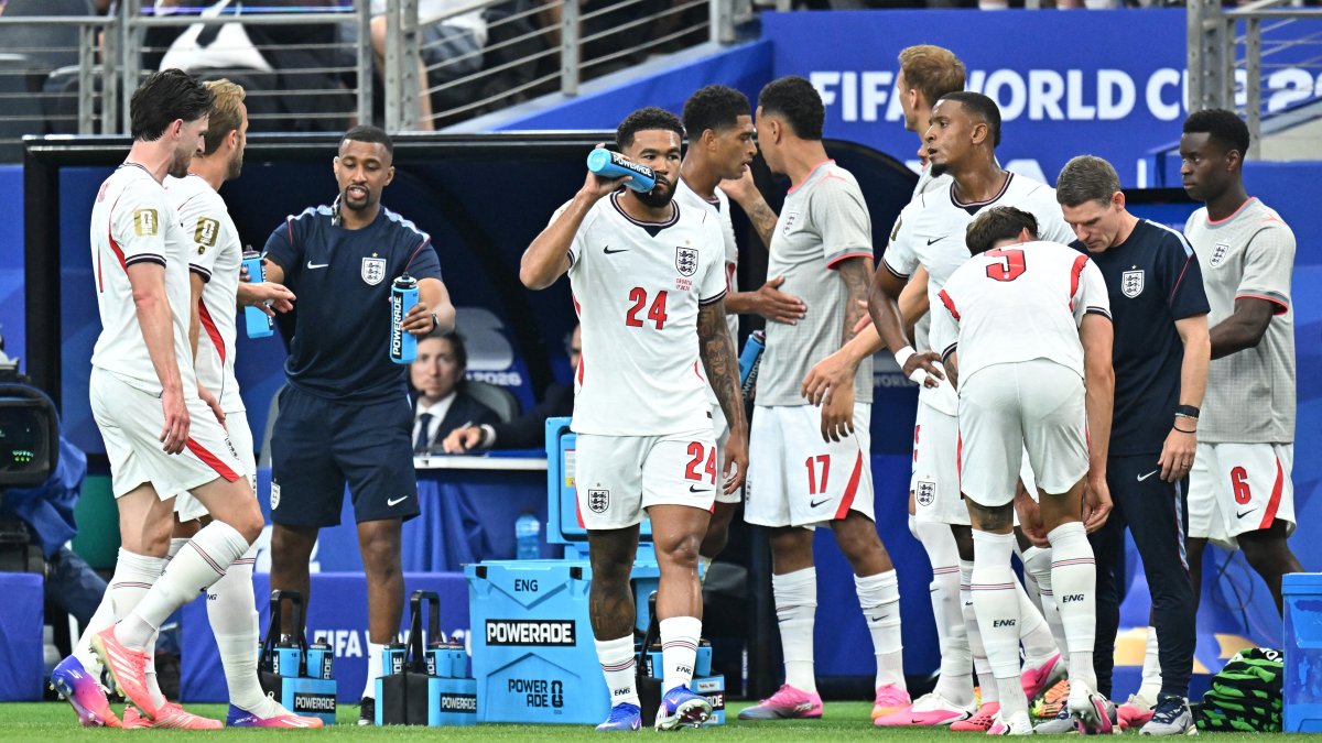 A coach speaking to players during a World Cup match break