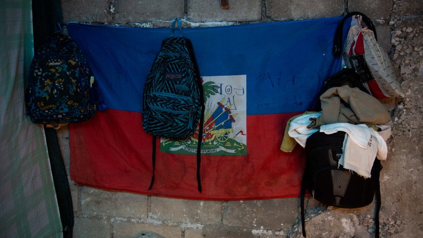 Backpacks and belongings of a family who fled gang violence hang on the wall in a newly opened shelter near the National Palace in Port-au-Prince, Haiti, on March 31, 2025. The United Nations High Commissioner for Human Rights, Volker Turk, on March 28, 2025, said that the situation in Haiti was worsening as armed gangs seize territory, team up and increasingly turn their violence on the population. (Photo by Clarens SIFFROY / AFP) (Photo by CLARENS SIFFROY/AFP via Getty Images)
