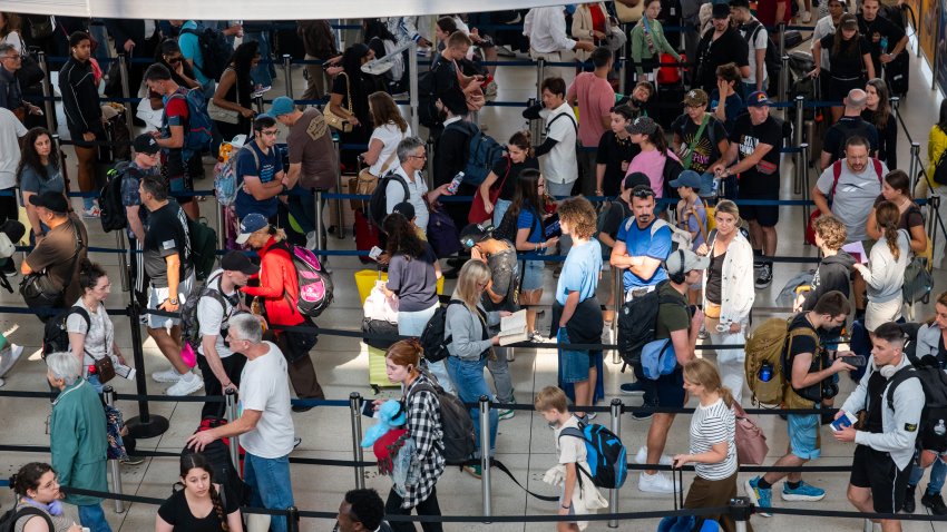 NEW YORK, NEW YORK – AUGUST 12: People wait in a security line at John F. Kennedy International Airport on August 12, 2026 in the Queens borough of New York City. A union representing 47,000 Transportation Security Administration (TSA) workers is suing the TSA over a new program introduced by the Trump administration aimed at expanding the privatization of airport security screening called TSA Gold+. The union claims that the private-public partnership for TSA Gold+, which would allow airports to hire outside contractors for airport security, was carried out without formal disclosure or the union’s involvement.  (Photo by Spencer Platt/Getty Images)